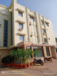 two motorcycles parked in front of a building at Vamoose Sujata Residency in Sundargarh