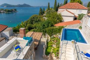 a villa with a swimming pool and a view of the water at Villa Baburizza in Koločep