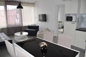 a kitchen and living room with a couch and a table at Apartman WALKOW in Vukovar