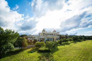 a large building on a grassy field with trees at Duni Belleville - All Inclusive in Sozopol
