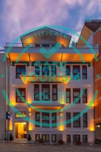 a tall white building with a sign on it at Blue Gilroy Hotel in Istanbul