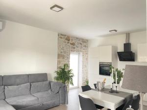 a living room with a couch and a table at Holiday House Lucia in Sukošan