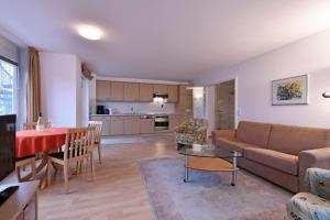 a living room with a couch and a table at BER-511-Appartementresidenz in Scharbeutz