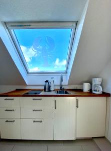 a kitchen with a window with a spider on it at Haus Germania in Helgoland