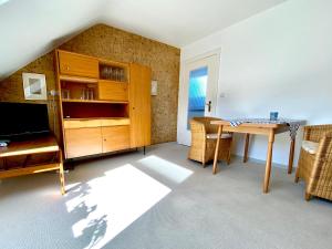 a living room with a table and a dining room at Haus Germania in Helgoland