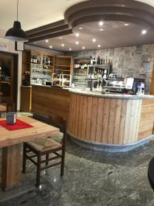 a restaurant with a wooden bar with a wooden table at Albergo Ristorante Dal Cogo in Spert