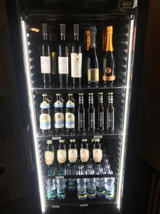 a refrigerator filled with lots of bottles of alcohol at Albergo Ristorante Dal Cogo in Spert