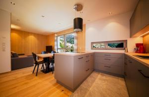 a kitchen with a table and a dining room at Camping Zögghof in San Leonardo in Passiria