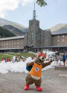 a person dressed as a bear standing in front of a building at Apartaments Vall de Núria in Queralbs