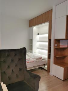 a bedroom with a bed and a mirror at LUXURY APARTMENT in Warsaw