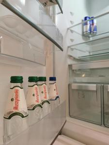 a refrigerator filled with bottles of milk at LUXURY APARTMENT in Warsaw