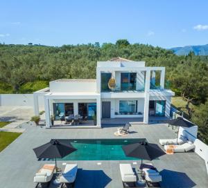 an aerial view of a house with a swimming pool at ELYSIAN VILLA in Amoudi