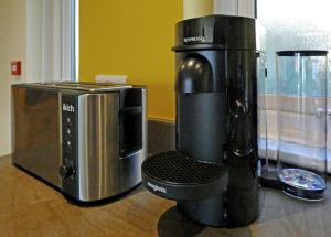 a coffee maker and a microwave on a counter at Bryn Melyn Apartments in Barmouth