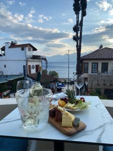 a table with a plate of food and wine glasses at Mono Hotel in Antalya