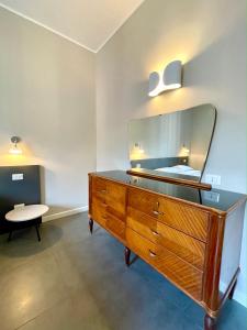 a dresser with a mirror on top of it in a room at Maison A in La Spezia +5 photos