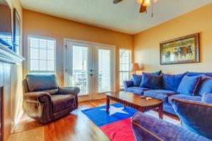 a living room with blue couches and a coffee table at Texas on the Lake in Lago Vista