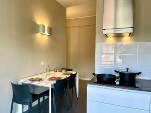 a kitchen with a table with chairs and a stove at Maison A in La Spezia