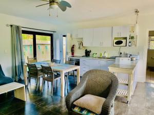 a kitchen with a table and chairs in a kitchen at Moonriver Self Catering in Plettenberg Bay