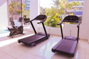 a gym with two tread machines in a room at Aram Beach & Convention in João Pessoa