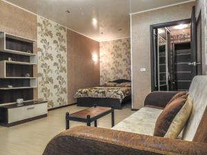 チェレポヴェツにあるКомфортные апартаментыのリビングルーム(ベッド2台、ソファ付)