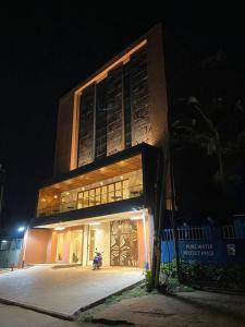 a building with a building with graffiti on it at night at Millennium Terrace Hotel in Kampala