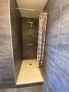 a bathroom with a shower with a shower curtain at Appartement du Val de Loire in Tours