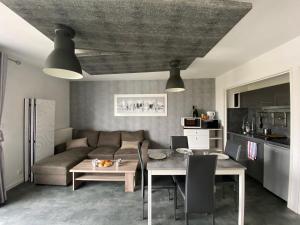 a living room with a couch and a table at Appartement du Val de Loire in Tours