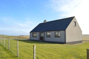 a small house in the middle of a field at Kilronan Self Catering - Eoropie, Isle of Lewis in Eoropie