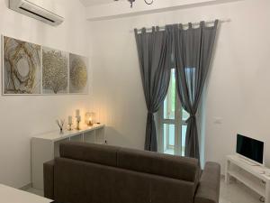 uma sala de estar com um sofá e uma janela em Luxury Apartment in Rome Countryside - Francigena em Campagnano di Roma