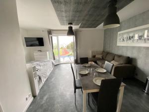 a living room with a table and a couch at Appartement du Val de Loire in Tours +5 photos