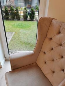a chair sitting in front of a window at LUXURY APARTMENT in Warsaw