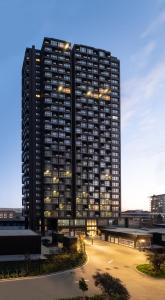 a large black building with lights on it at G Tower Furnished Apartment Rentals in Istanbul