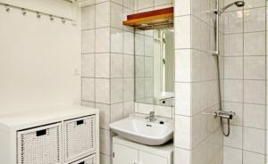 a white bathroom with a sink and a mirror at Sct Knudsborg - 12E - Apartment on the beach in Brenderup +21 photos