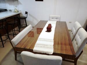 - une table à manger avec des chaises blanches et une table en bois dans l'établissement Casa con Alberca a solo 5 minutos de Playas de Nuevo Vallarta RBL33, à Nuevo Vallarta