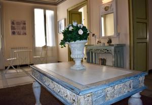 a vase with flowers on a table in a room at Il Sogno Maison de Charme in Chiavari