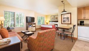 a living room with a kitchen and a bedroom at WorldMark Canmore-Banff in Canmore