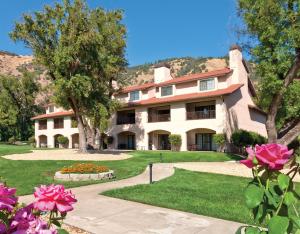 an exterior view of a building with pink flowers at WorldMark Clear Lake in Nice