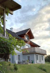 duży biały dom z drewnianym dachem w obiekcie Grimming Appartement Schladming w mieście Sonnberg
