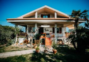 a house with palm trees in front of it at L'Isola che non c'è in Senigallia