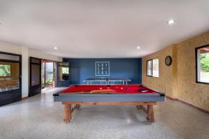 a pool table in a room with blue walls at Soy Local Guatape in Guatapé