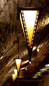 a light hanging from a ceiling with lights at Mathias Rex in Szentendre