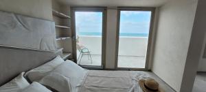 a bedroom with a bed with a view of the ocean at Villaggio Camping Oasi in Vieste