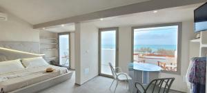 a bedroom with a bed and a view of the ocean at Villaggio Camping Oasi in Vieste