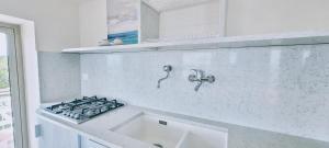 a kitchen with a sink and a stove at Villaggio Camping Oasi in Vieste