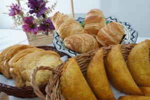 einen Korb mit Brot und Gebäck auf dem Tisch in der Unterkunft Hotel Boutique los Remansos in Palmira