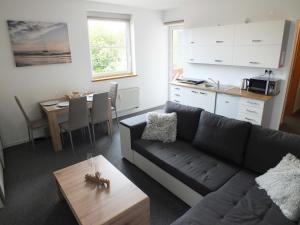 a living room with a couch and a table at MyMara, Apartmán Beťo in Bešeňová