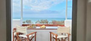 a kitchen with a view of the ocean from a balcony at Villaggio Camping Oasi in Vieste