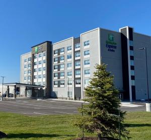 a building with a christmas tree in front of it at Holiday Inn Express & Suites - Aurora by IHG in Aurora