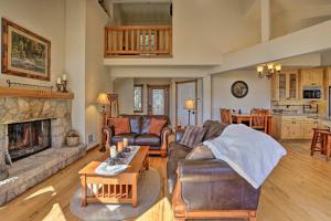 a living room with a couch and a fireplace at Family Cabin with Lake Arrowhead and Mountain Views! in Lake Arrowhead