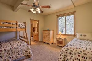 a bedroom with two bunk beds and a window at Family Cabin with Lake Arrowhead and Mountain Views! in Lake Arrowhead